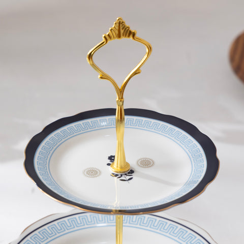 Gold stand on a decorative plate with intricate patterns