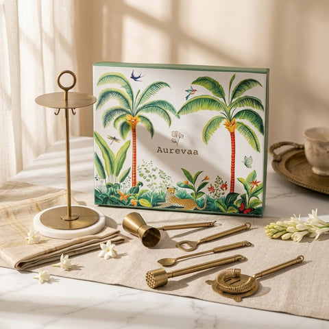Branding box with palm tree design and Aurevaa branding, surrounded by gold cocktail tools on a marble surface.