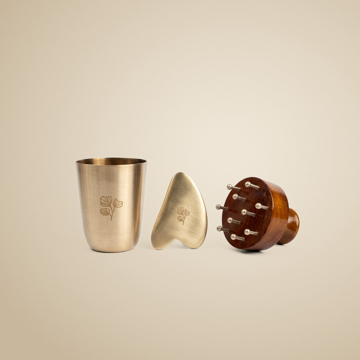 The Art of Self Care set: engraved kansa cup, gua sha and wooden scalp massager on warm linen