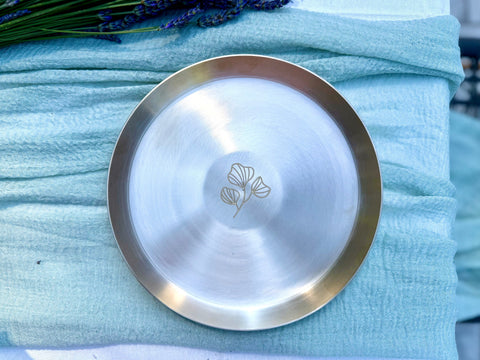 Kansa snack plate with floral motif closeup