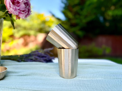 Kansa cup styled with herbal tea showing the 250 ml size