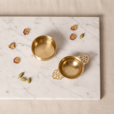 Lotus Pour brass loose leaf tea strainer shown from both sides revealing the perforated bowl