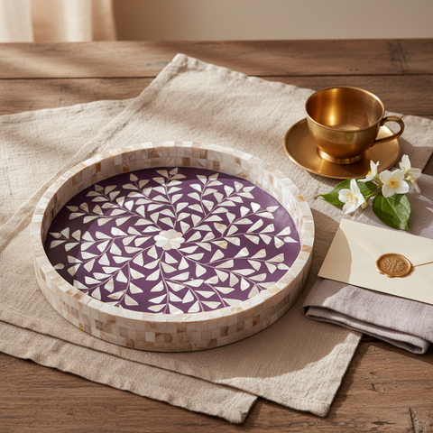 A violet Round Tray with Mother Of Pearl Inlay on a wooden table with a cup and napkin.