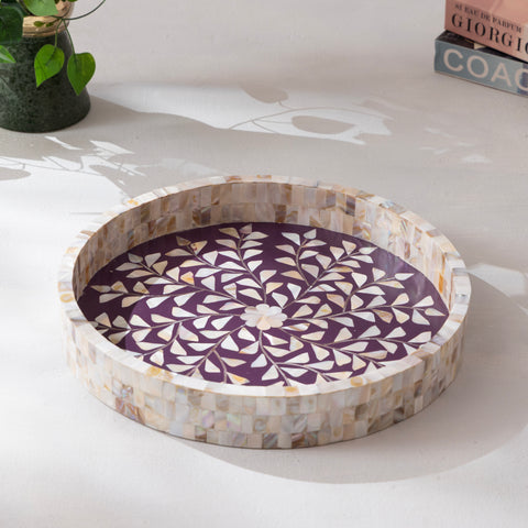 Round decorative tray with a purple geometric pattern on a white surface