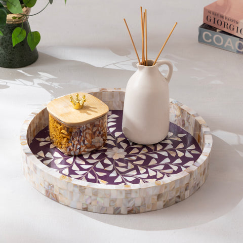 Decorative tray with a white vase and jar on a light surface