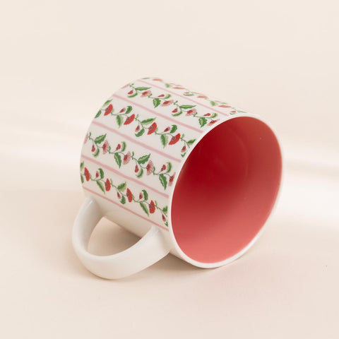 Ceramic coffee and tea mug featuring bold red flowers and blush pink glaze inside